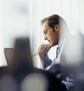 Businessman using phone in office Businessman using phone in office